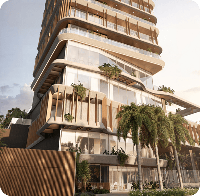 Fachada do empreendimento Quadra Aura — torre residencial com varandas orgânicas e vegetação.