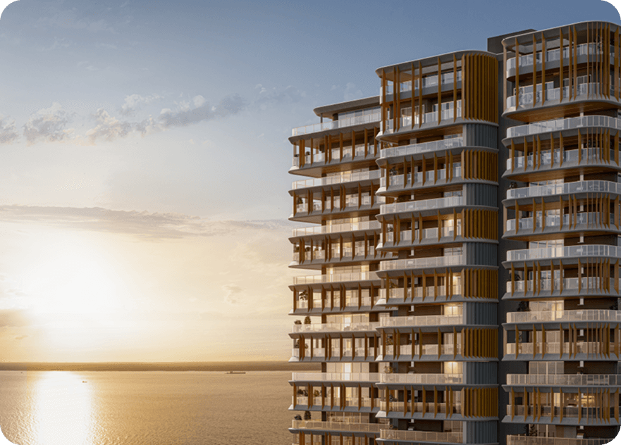 Quadra Aura — torre residencial com vista para a baía ao entardecer